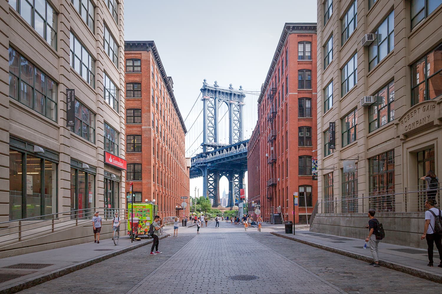 The Manhattan Bridge framed by red-brick DUMBO warehouses on Washington Street in Brooklyn